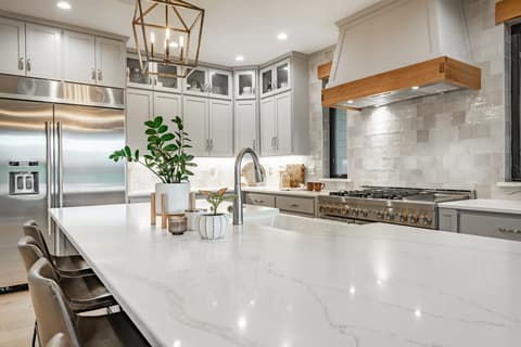 Sparkling kitchen countertop with staged coffee station and fresh flowers